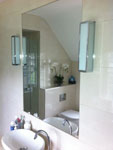Bathroom mirror recessed into tiles